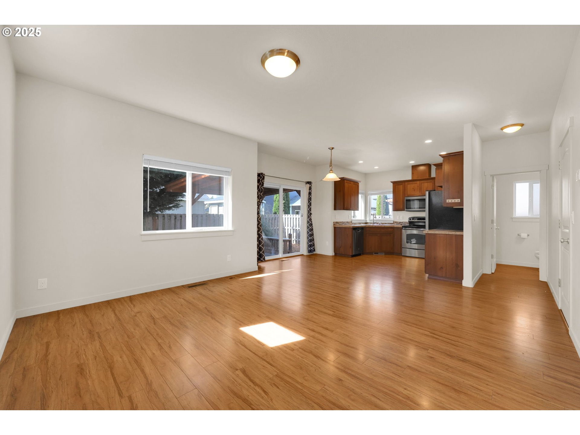 490 Raber Road Eugene, OR 97402 - Photo 4 of 37 a view of a livingroom with furniture wooden floor and kitchen