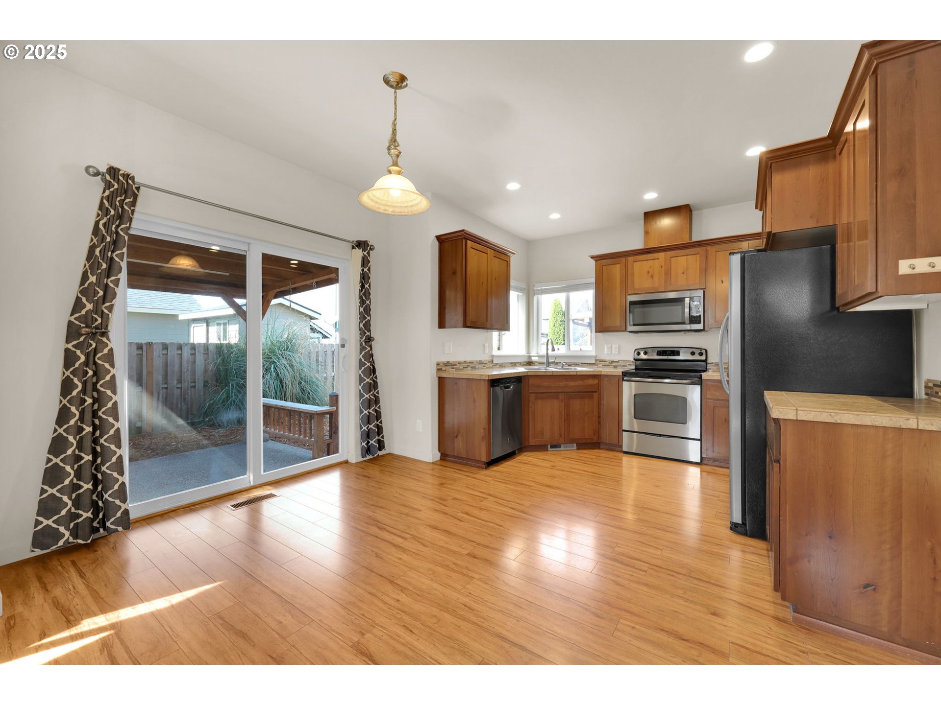 490 Raber Road Eugene, OR 97402 - Photo 9 of 37 a kitchen with stainless steel appliances kitchen island granite countertop a refrigerator a oven a sink with island and chairs