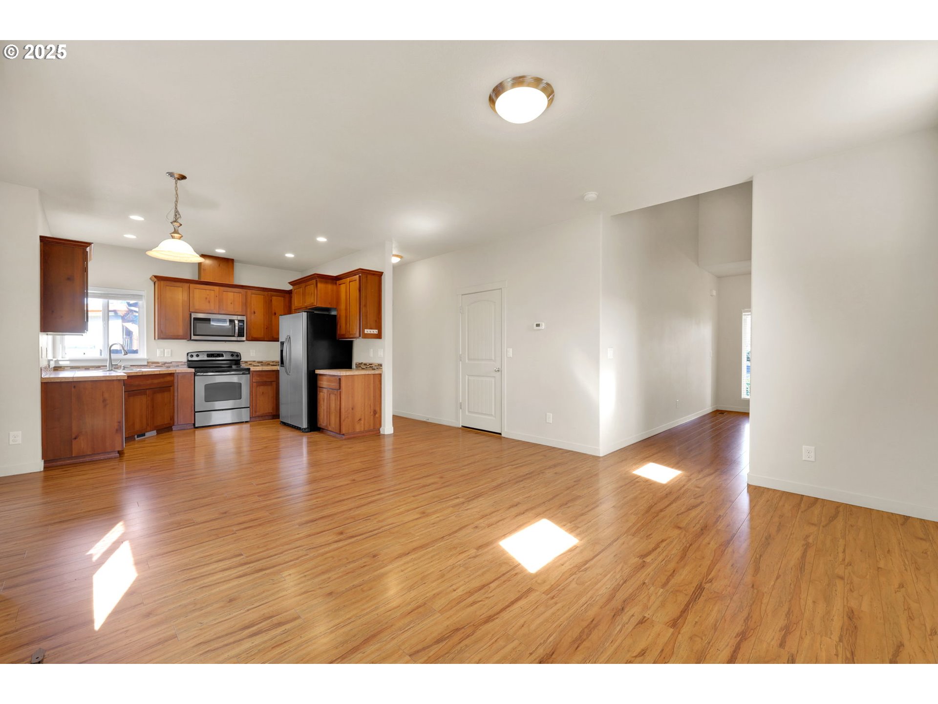 490 Raber Road Eugene, OR 97402 - Photo 10 of 37 a view of kitchen and kitchen with furniture wooden floor