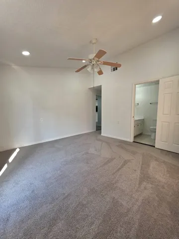 a view of an empty room with a fan