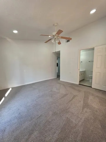 a view of an empty room with a fan