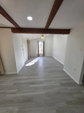 a view of an empty room and wooden floor