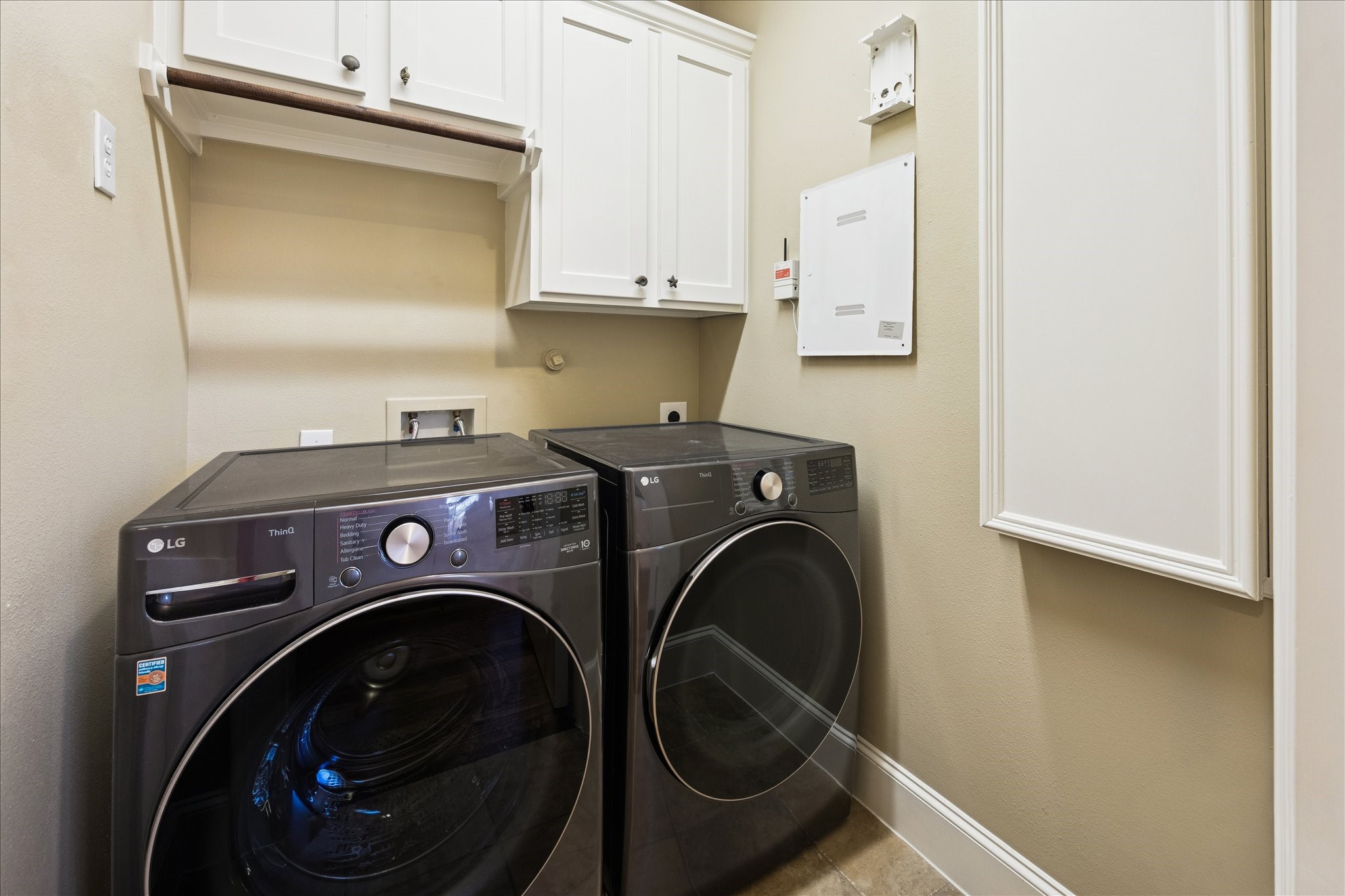 840 Alexander Street Houston, TX 77007 - Photo 24 of 39 The very well executed laundry room includes new (2024) gas washer and dryer. To the right is a built in fold out ironing board. To the left (not in this picture) is a laundry shoot between the primary bath and laundry room. Vacuum included!