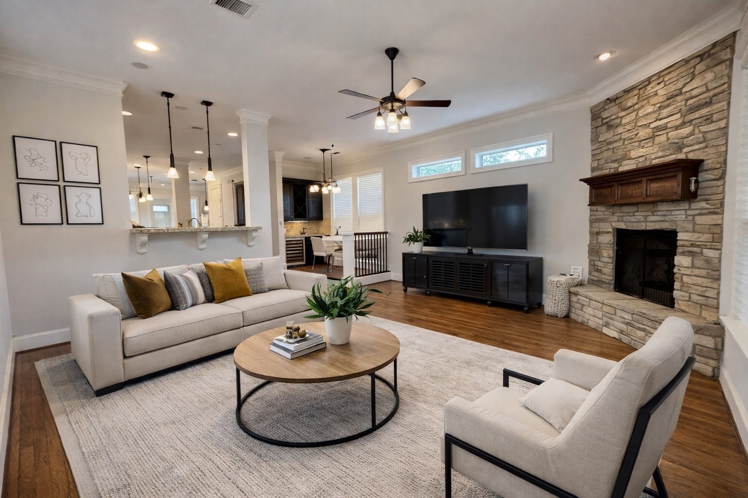 840 Alexander Street Houston, TX 77007 - Photo 9 of 39 Experience cozy elegance in this virtually staged family room, featuring a custom fireplace and seamless access to the side yard and garage apartment through beautiful French doors.