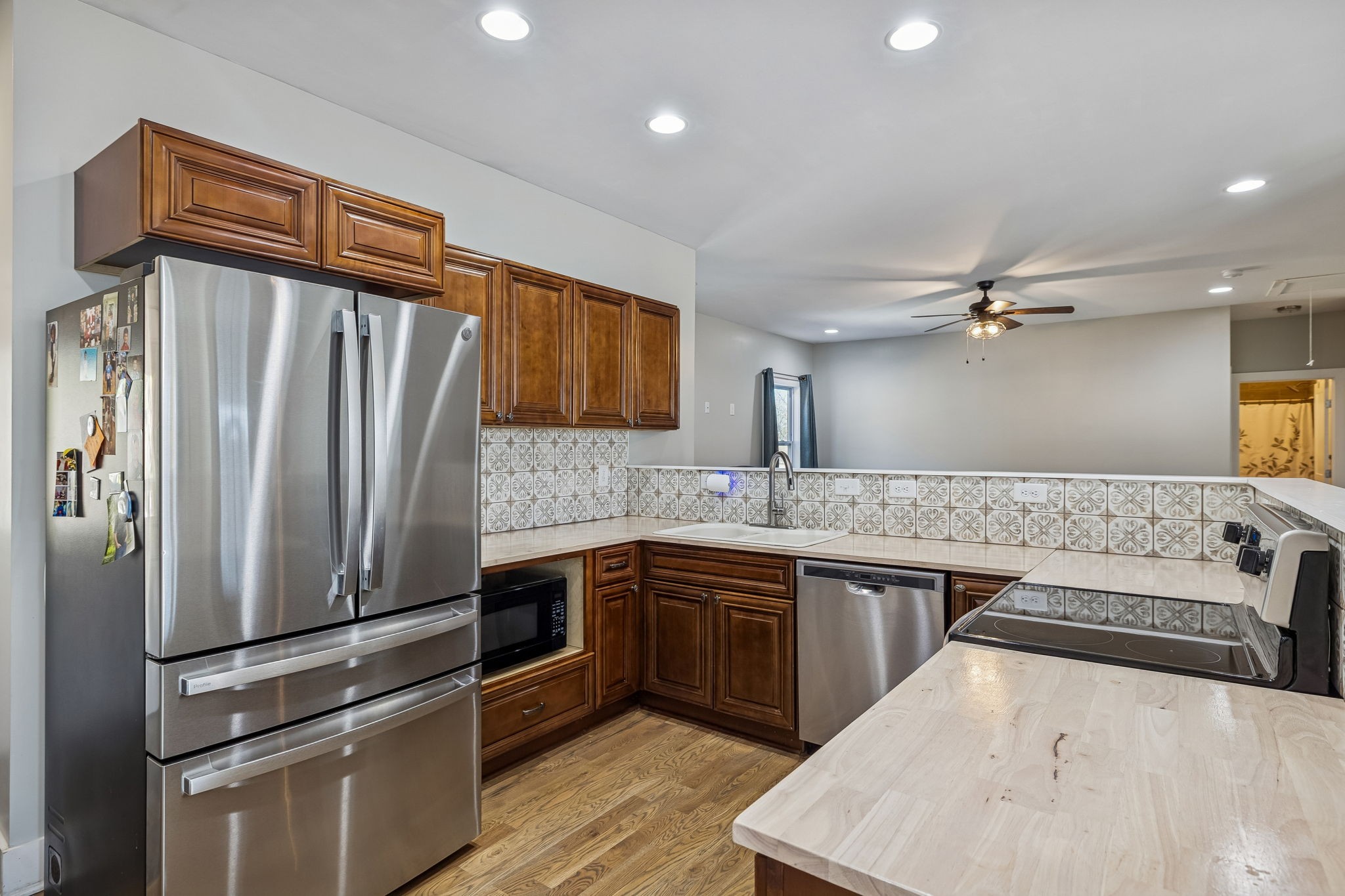 9681 Bud Qurriel Road Bon Aqua, TN 37025 - Photo 15 of 63 a kitchen with stainless steel appliances granite countertop a sink stove and refrigerator
