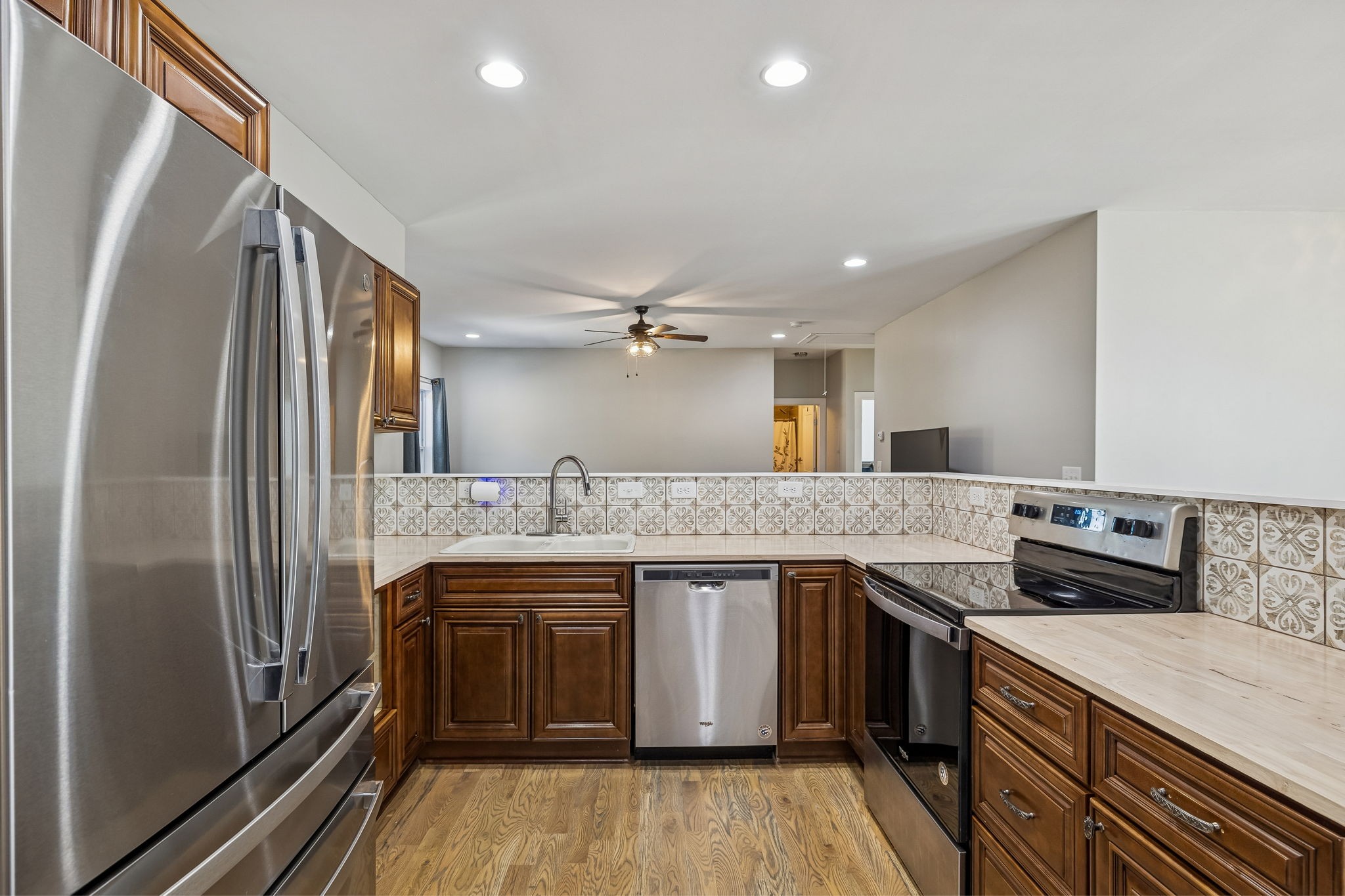 9681 Bud Qurriel Road Bon Aqua, TN 37025 - Photo 16 of 63 a kitchen with stainless steel appliances granite countertop a sink stove and refrigerator