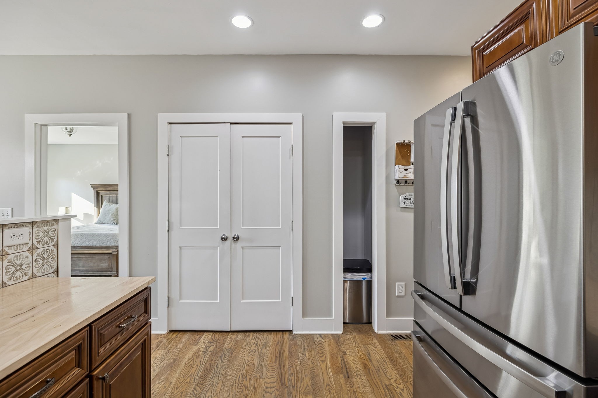 9681 Bud Qurriel Road Bon Aqua, TN 37025 - Photo 17 of 63 a view of kitchen with refrigerator and wooden floor