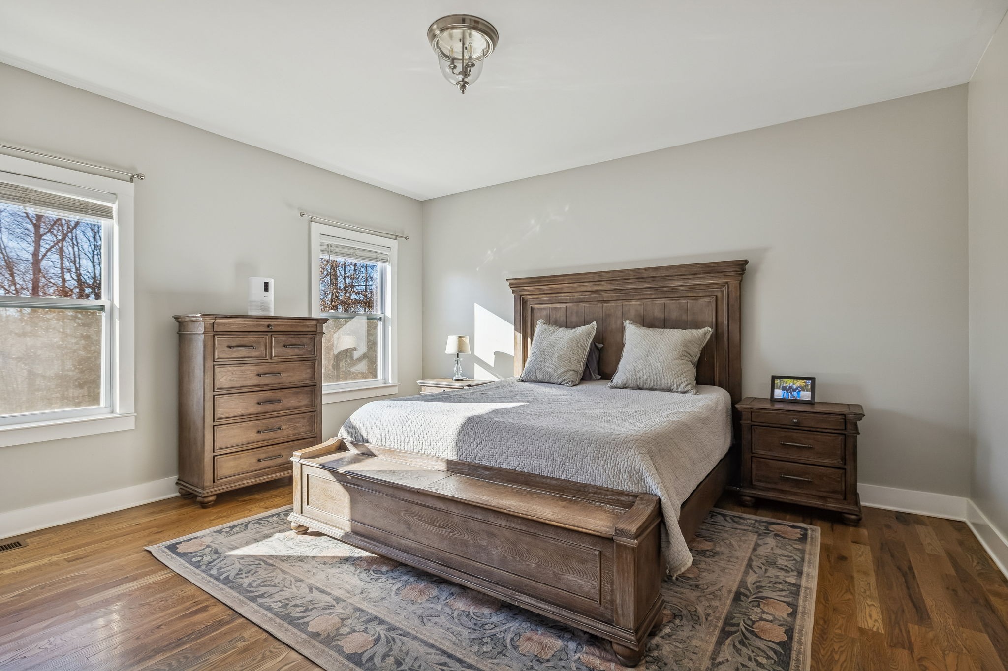 9681 Bud Qurriel Road Bon Aqua, TN 37025 - Photo 18 of 63 a bedroom with a bed a dresser and wooden floor