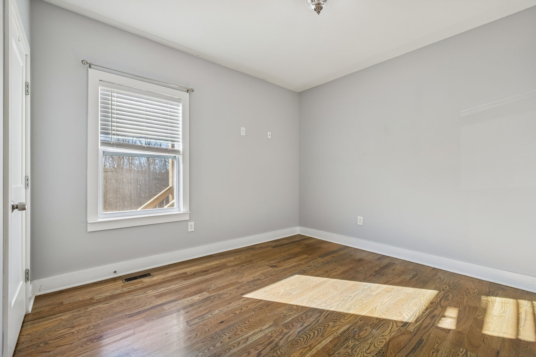 9681 Bud Qurriel Road Bon Aqua, TN 37025 - Photo 26 of 63 a view of an empty room with wooden floor and a window