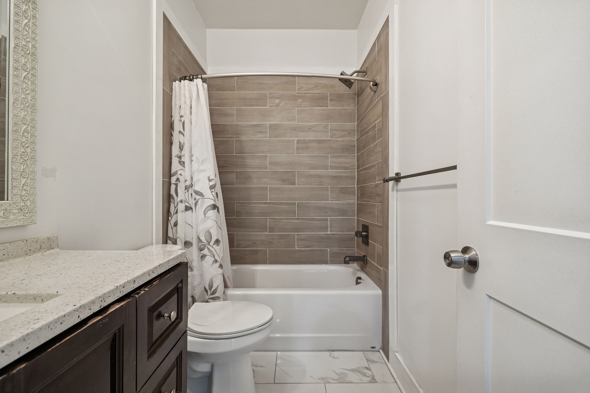 9681 Bud Qurriel Road Bon Aqua, TN 37025 - Photo 28 of 63 a bathroom with a granite countertop bathtub sink vanity mirror and toilet