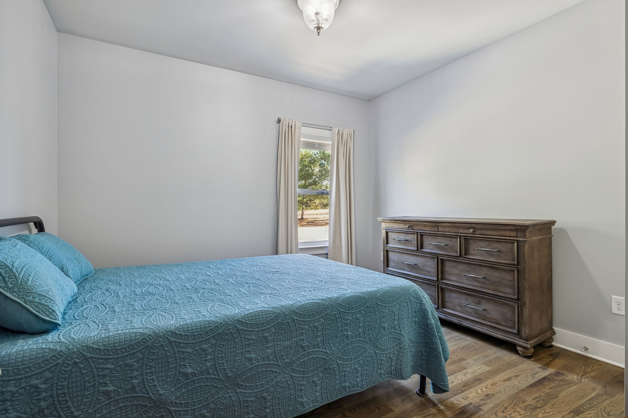 9681 Bud Qurriel Road Bon Aqua, TN 37025 - Photo 31 of 63 a bedroom with a bed a dresser and a window