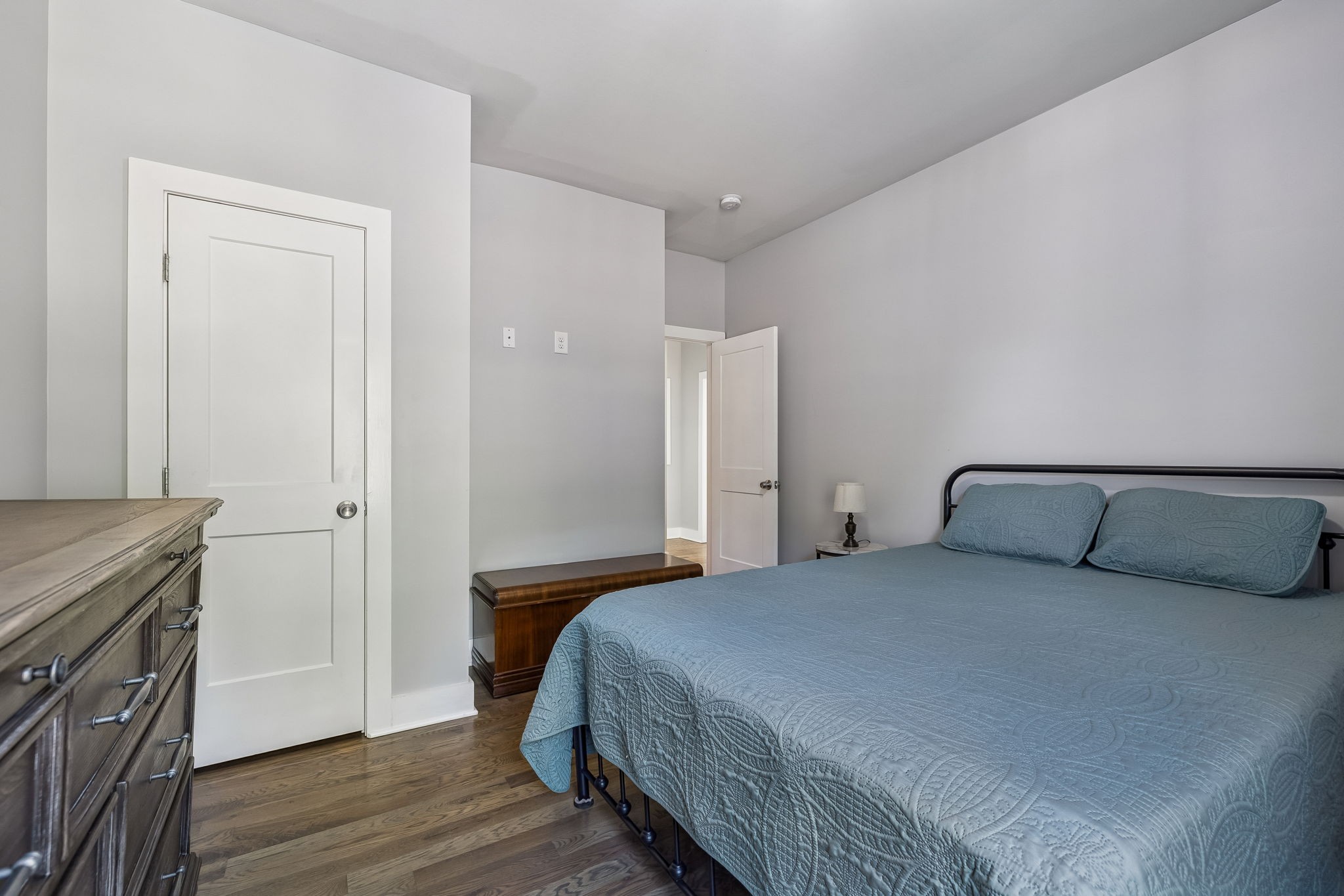 9681 Bud Qurriel Road Bon Aqua, TN 37025 - Photo 32 of 63 a bedroom with a bed and wooden floor