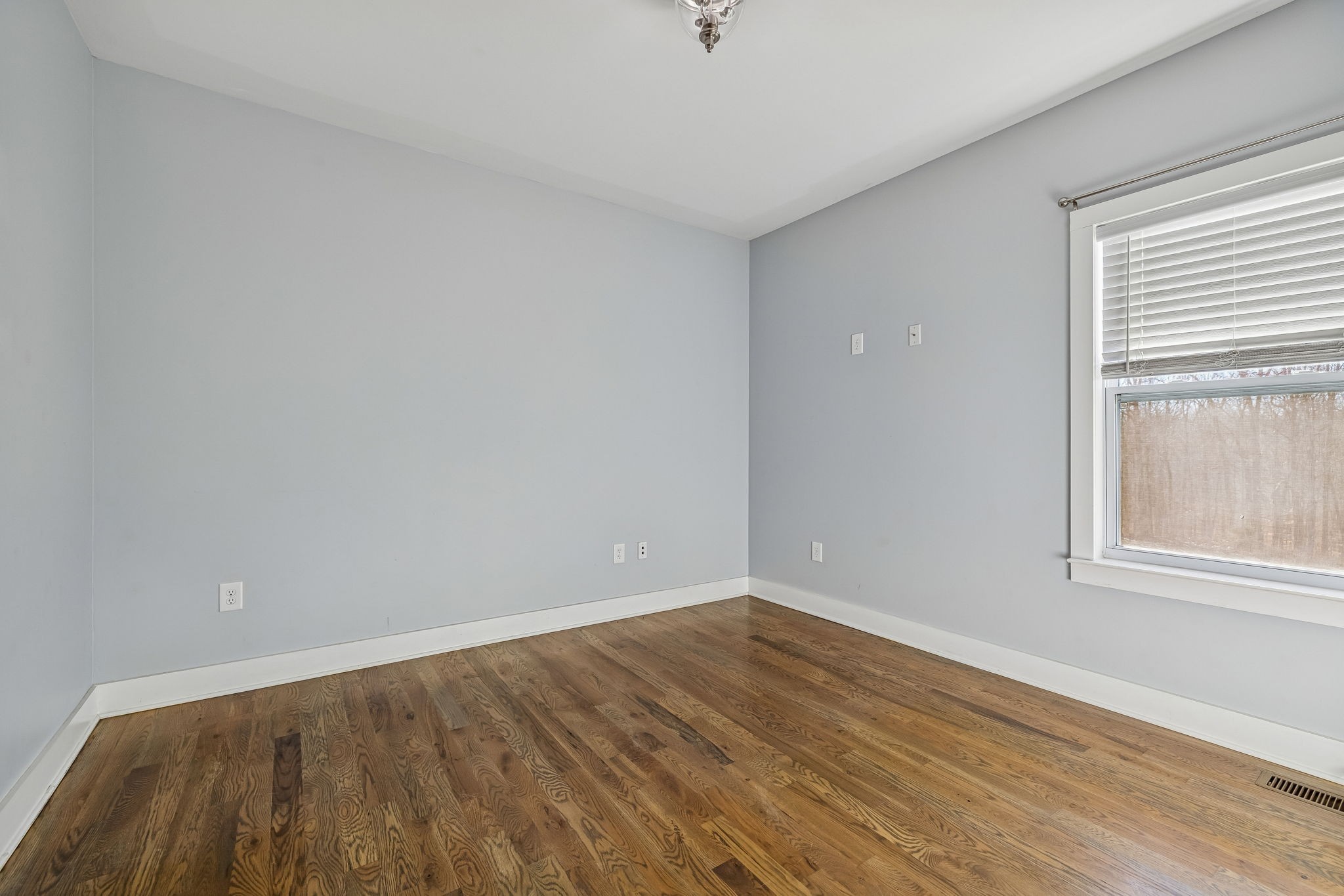 9681 Bud Qurriel Road Bon Aqua, TN 37025 - Photo 33 of 63 a view of an empty room with wooden floor and a window