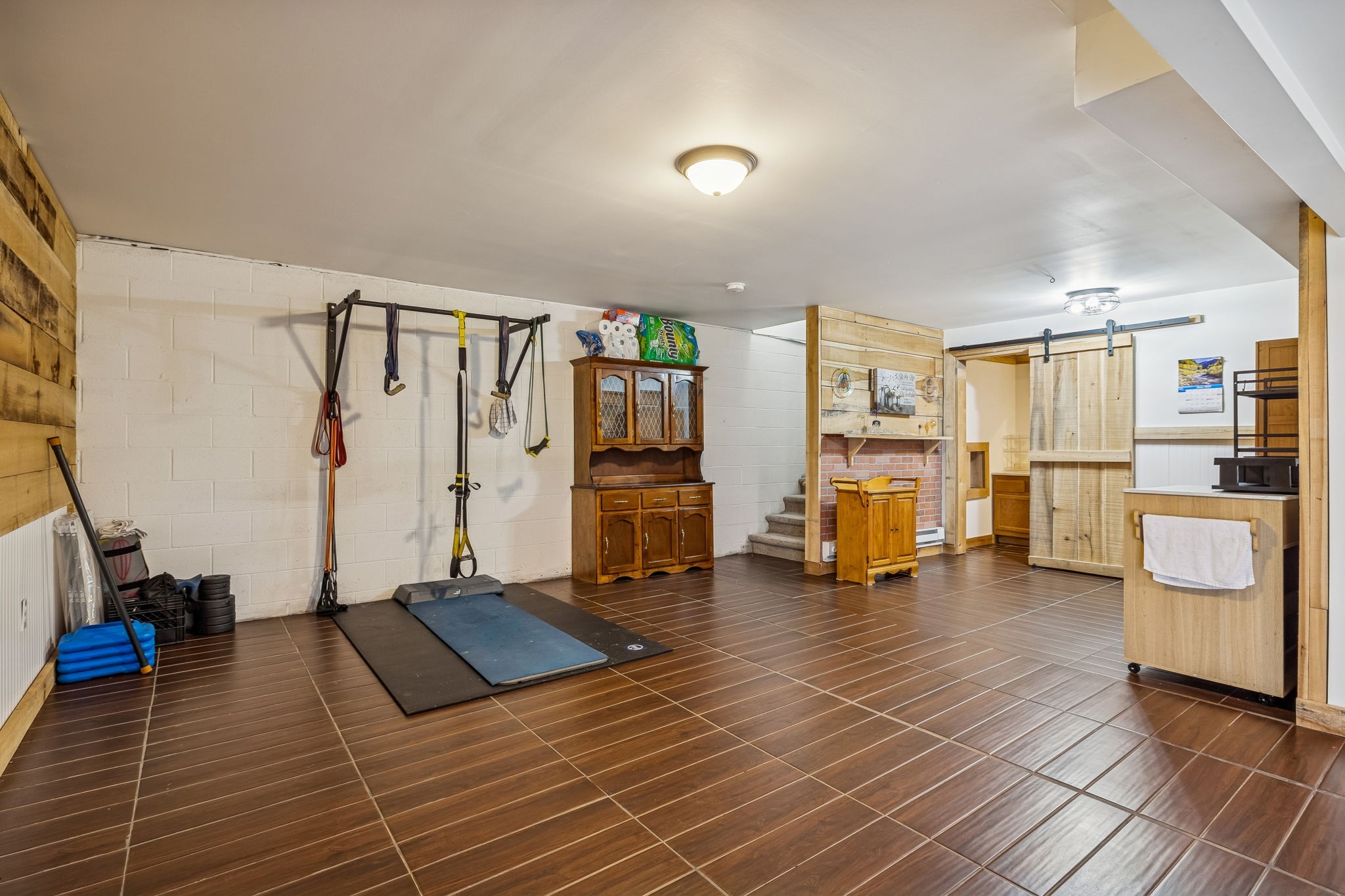 9681 Bud Qurriel Road Bon Aqua, TN 37025 - Photo 39 of 63 a view of a room with gym equipment and a large window