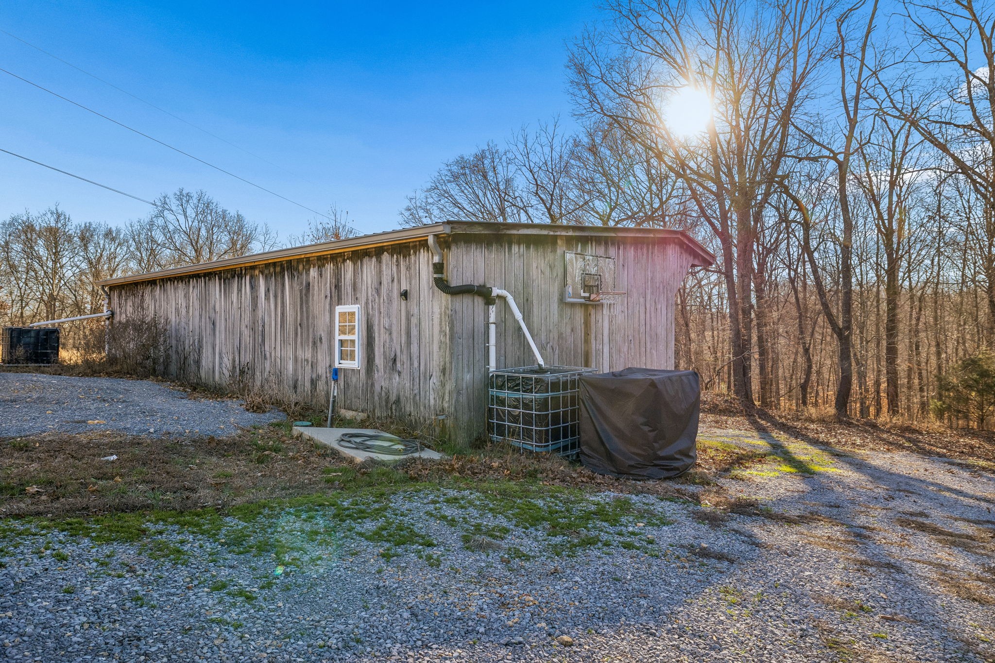 9681 Bud Qurriel Road Bon Aqua, TN 37025 - Photo 58 of 63 a backyard of house with large trees and wooden fence