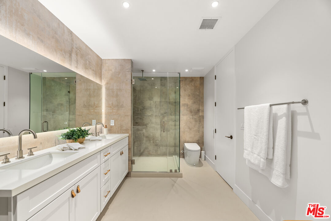 100 South La Jolla Avenue Los Angeles, CA 90048 - Photo 17 of 31 a bathroom with a double vanity sink mirror double and shower