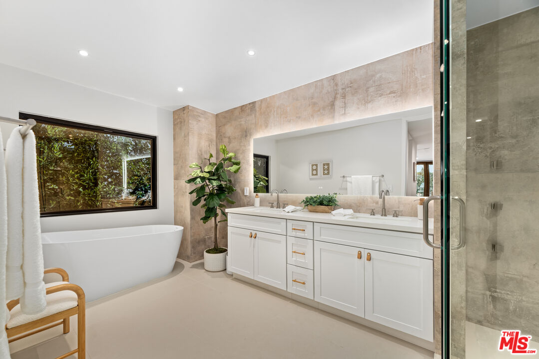 100 South La Jolla Avenue Los Angeles, CA 90048 - Photo 18 of 31 a bathroom with a granite countertop sink mirror and bathtub