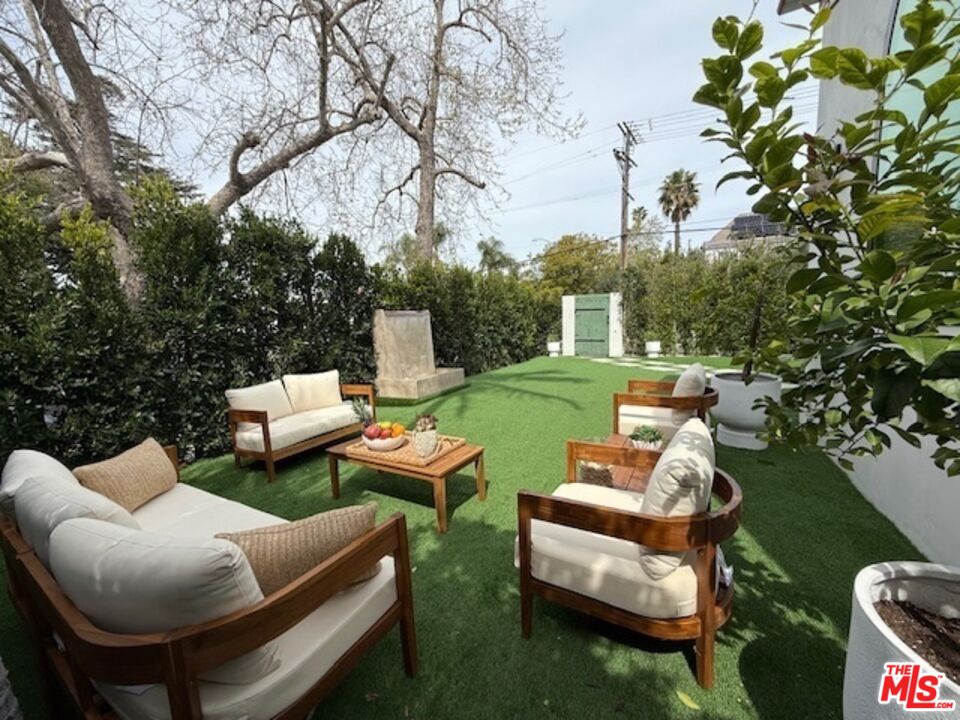 100 South La Jolla Avenue Los Angeles, CA 90048 - Photo 2 of 31 a view of a patio with couches table and chairs and potted plants