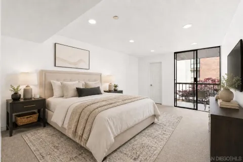 a bedroom with a large bed and a tv