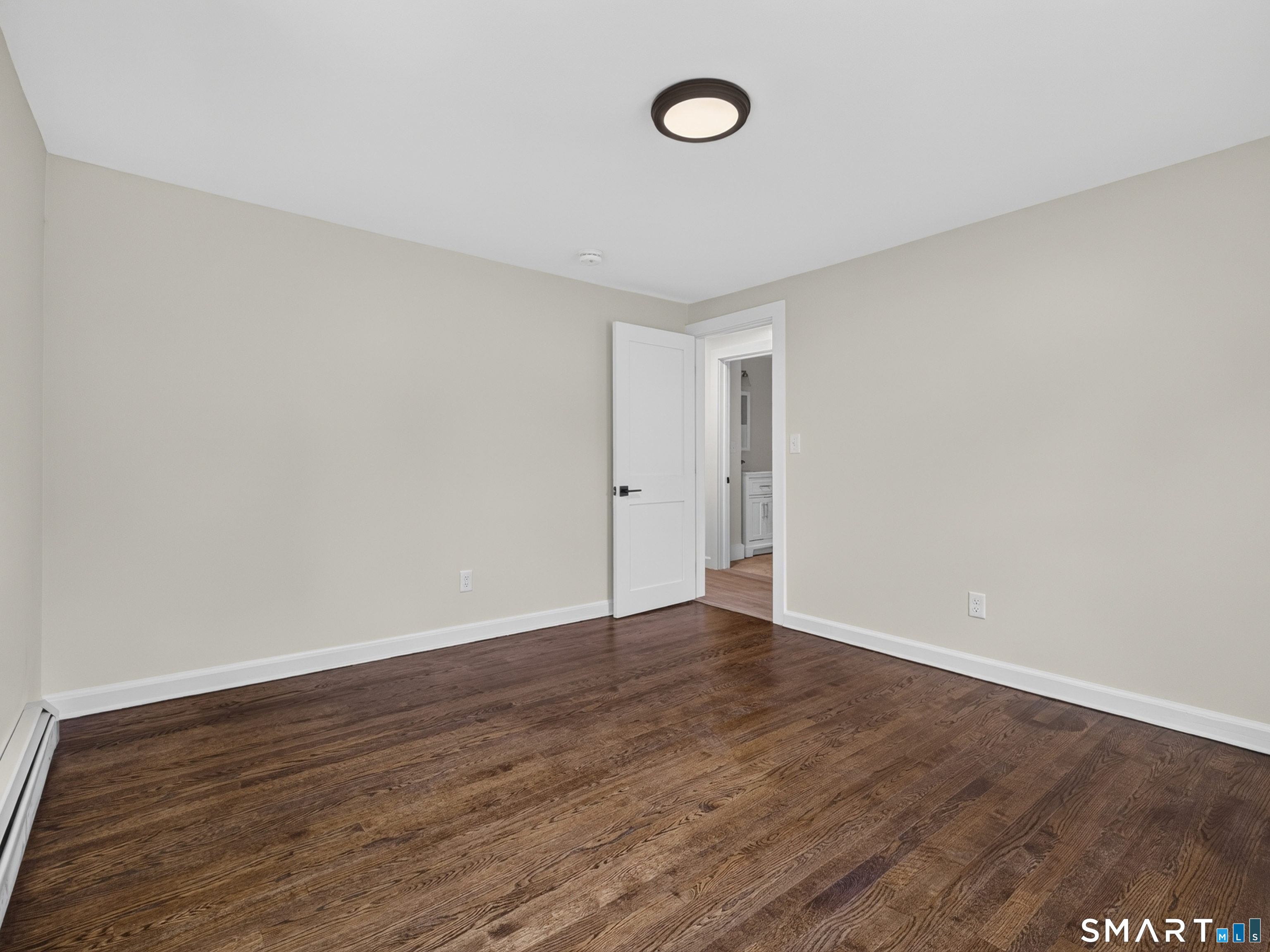 1039 N Road Groton, CT 06340 - Photo 12 of 26 a view of an empty room with wooden floor and a window