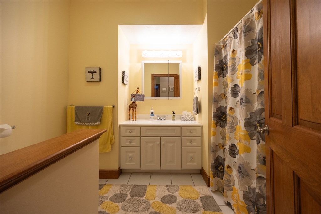 70 Azalea Way Hanson, MA 02341 - Photo 37 of 42 a bathroom with a sink a mirror and a shower