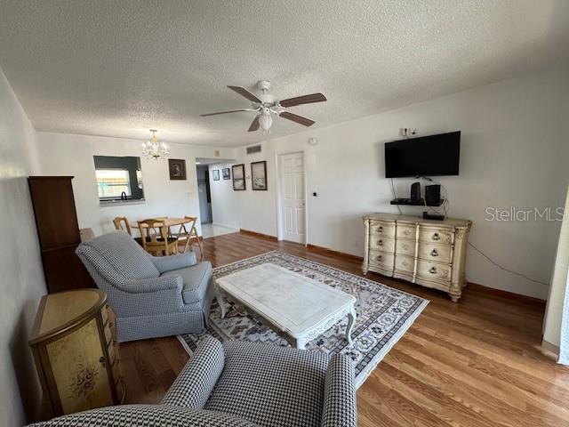 11485 Oakhurst Road, Unit 319 Largo, FL 33774 - Photo 9 of 63 a living room with furniture and a flat screen tv