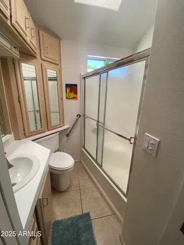 a bathroom with a toilet sink and a mirror