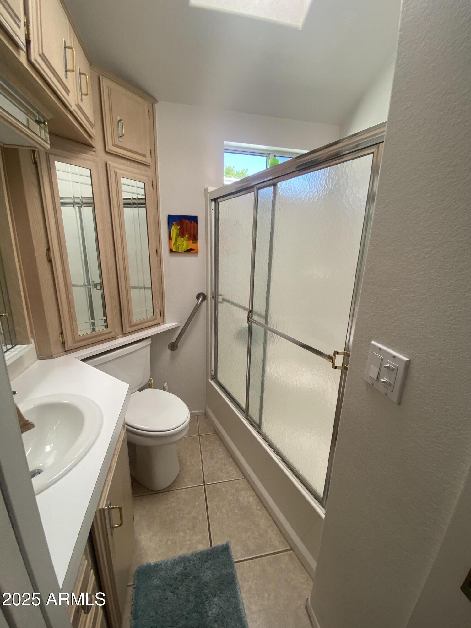 2072 West Klamath Avenue Apache Junction, AZ 85119 - Photo 13 of 25 a bathroom with a toilet sink and a mirror