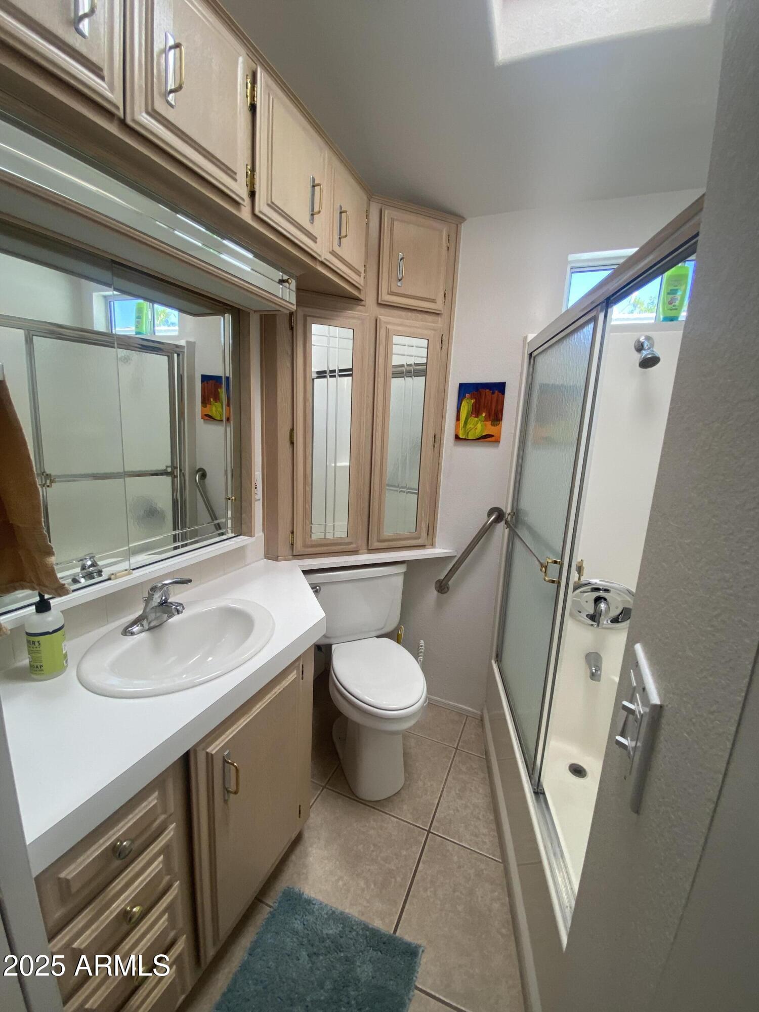 2072 West Klamath Avenue Apache Junction, AZ 85119 - Photo 15 of 25 a bathroom with a sink a toilet a mirror and vanity