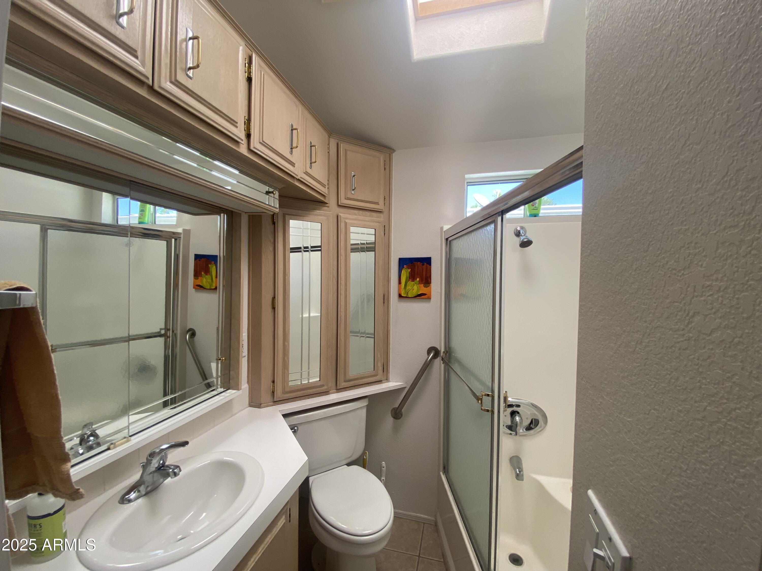 2072 West Klamath Avenue Apache Junction, AZ 85119 - Photo 16 of 25 a bathroom with a sink a toilet a mirror and shower