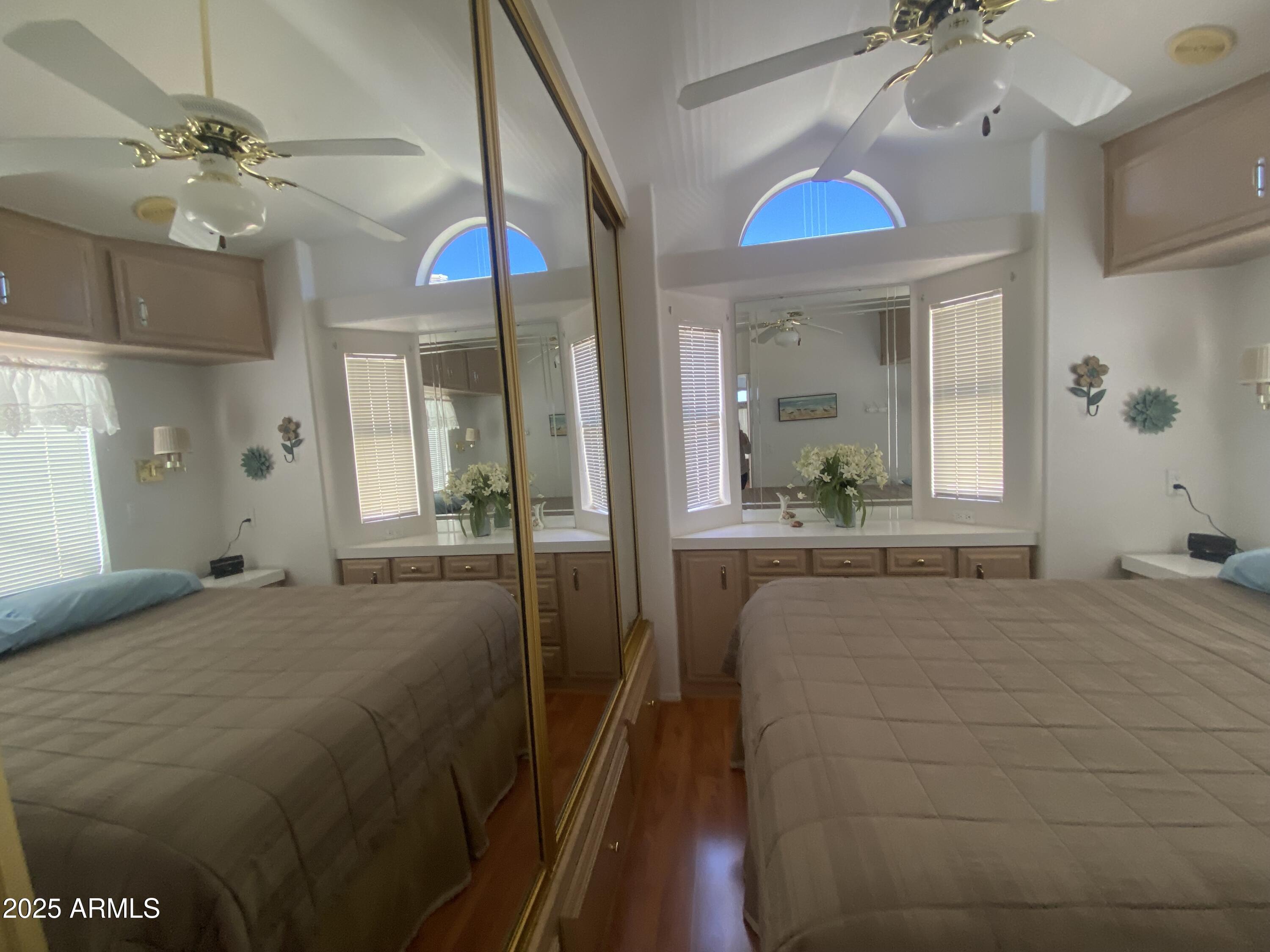 2072 West Klamath Avenue Apache Junction, AZ 85119 - Photo 18 of 25 a bedroom with a bed and a chandelier