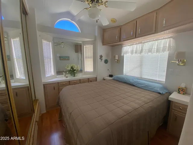 a bedroom with a bed and a chandelier