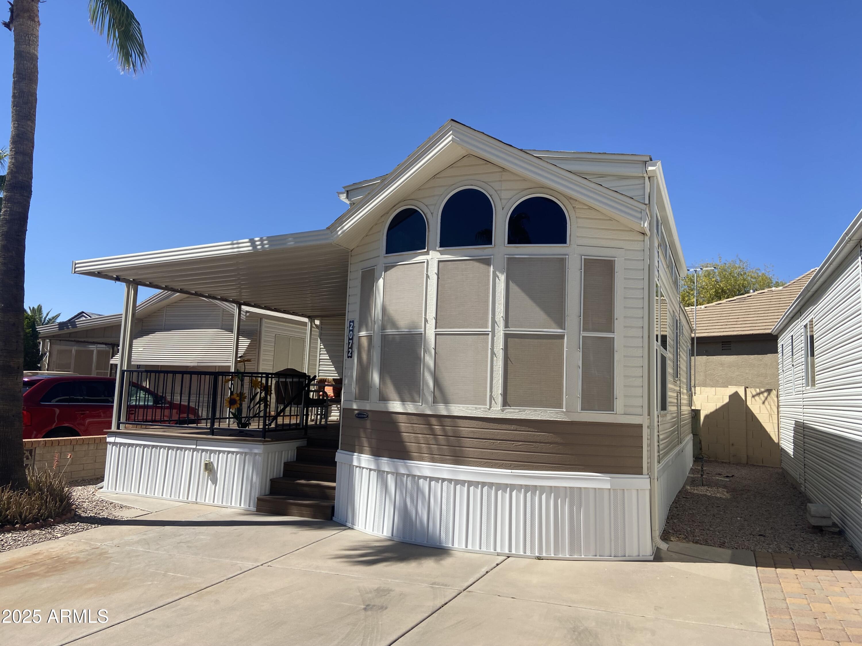 2072 West Klamath Avenue Apache Junction, AZ 85119 - Photo 22 of 25 a front view of a house with a porch