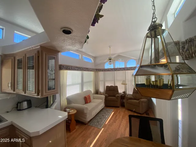 a living room with furniture and a chandelier