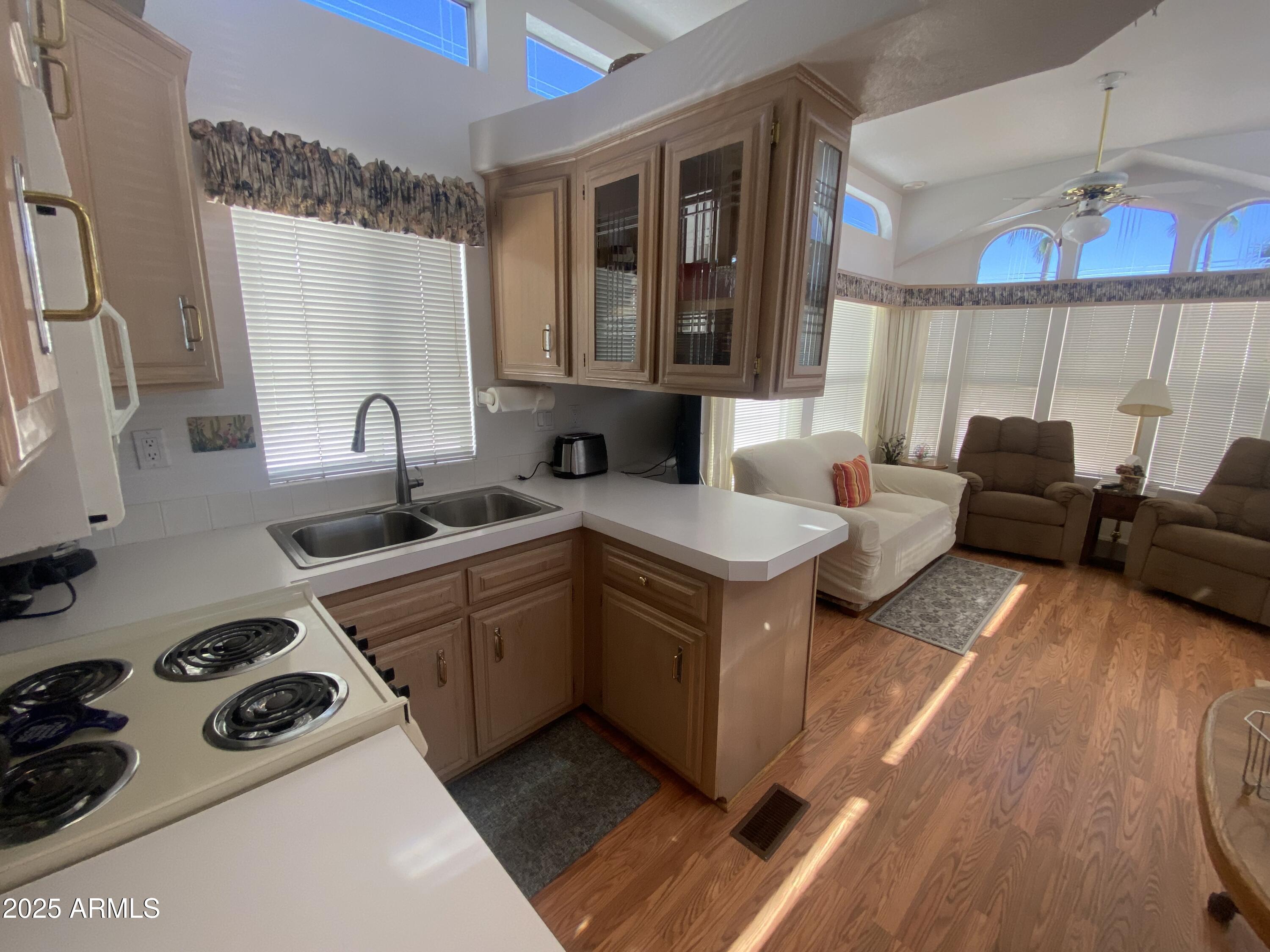 2072 West Klamath Avenue Apache Junction, AZ 85119 - Photo 6 of 25 a kitchen with a sink stove and cabinets