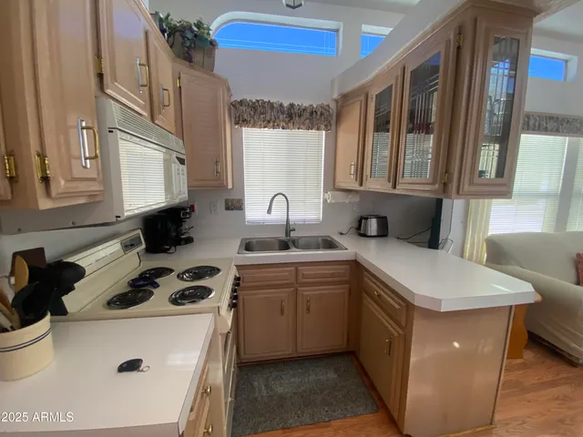 a kitchen with stainless steel appliances a sink stove and a refrigerator