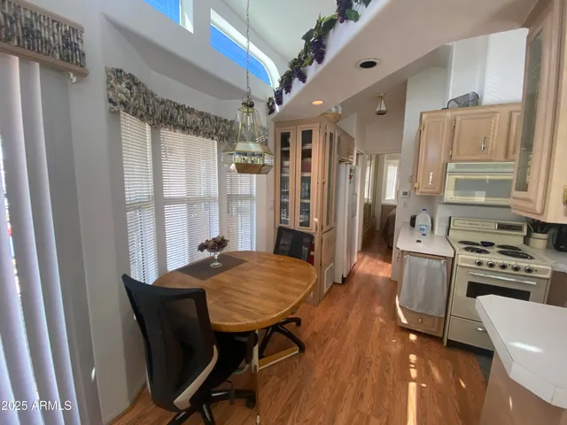 a kitchen with stainless steel appliances granite countertop a stove a refrigerator and a dining table
