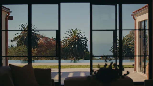 a view of a patio with couches table and chairs with wooden floor and fence