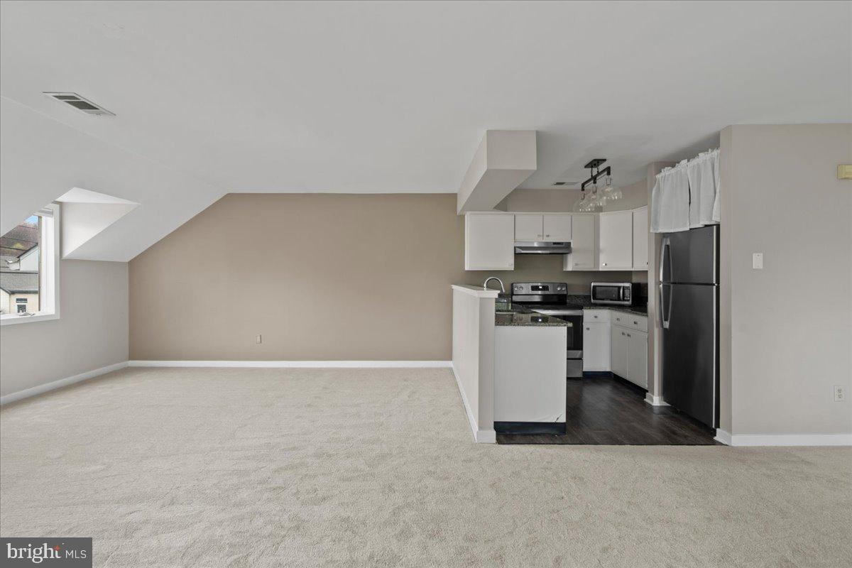 1 Center Street Doylestown, PA 18901 - Photo 5 of 12 a kitchen with a refrigerator and white cabinets