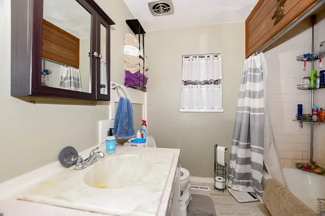 a bathroom with a bathtub and shower