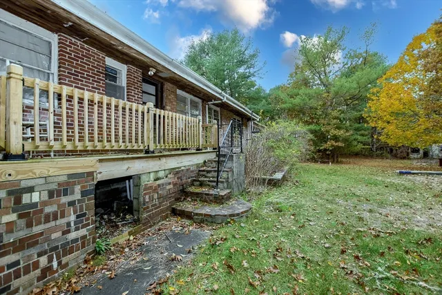 a view of balcony with wooden floor and fence