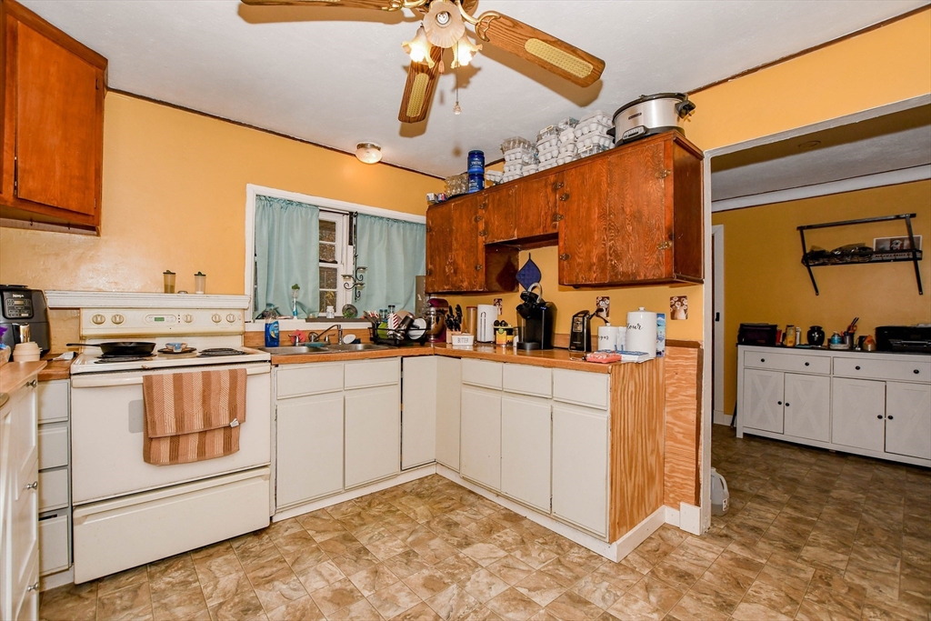 6 Gilbert Way Wareham, MA 02571 - Photo 4 of 42 a kitchen with white cabinets and white appliances