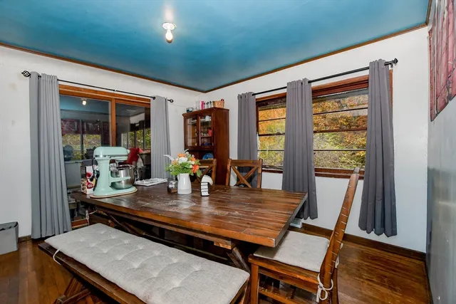 a view of a dining room with furniture window and wooden floor