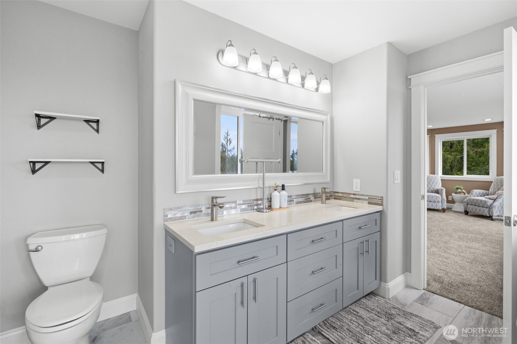 9916 Dishman Road Northwest Bremerton, WA 98312 - Photo 22 of 40 a spacious bathroom with a toilet sink and mirror