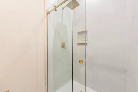 a bathroom with a shower and toilet