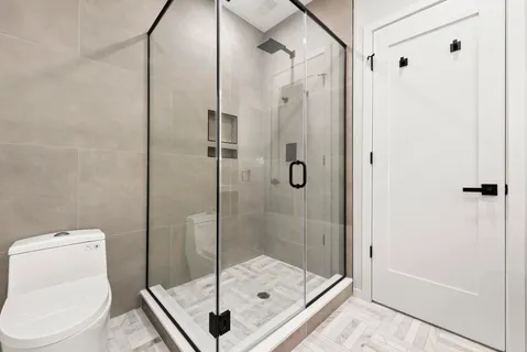 a bathroom with a shower and a sink