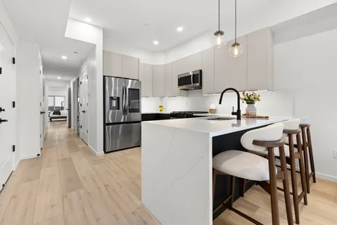 a kitchen with a sink appliances and cabinets