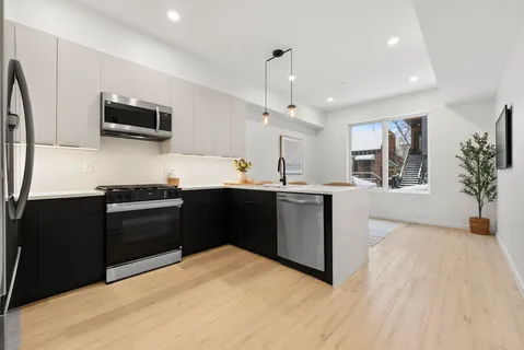 a kitchen with stainless steel appliances granite countertop a refrigerator and a sink