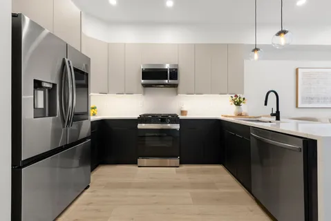 a kitchen with a sink cabinets and window