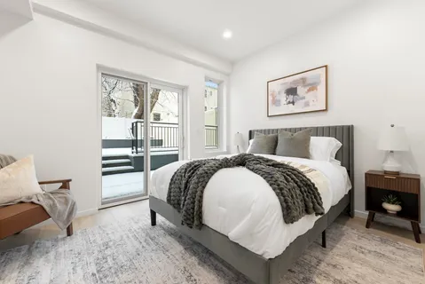 a bed room with a bed and a chair